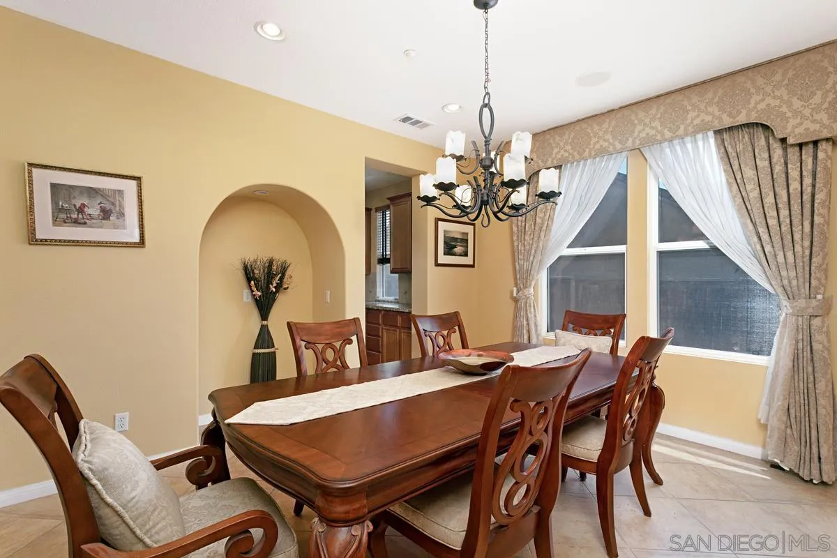 604 Hidden Trails Road Escondido, CA 92027 - Photo 5 of 49 a view of a dining room with furniture and chandelier