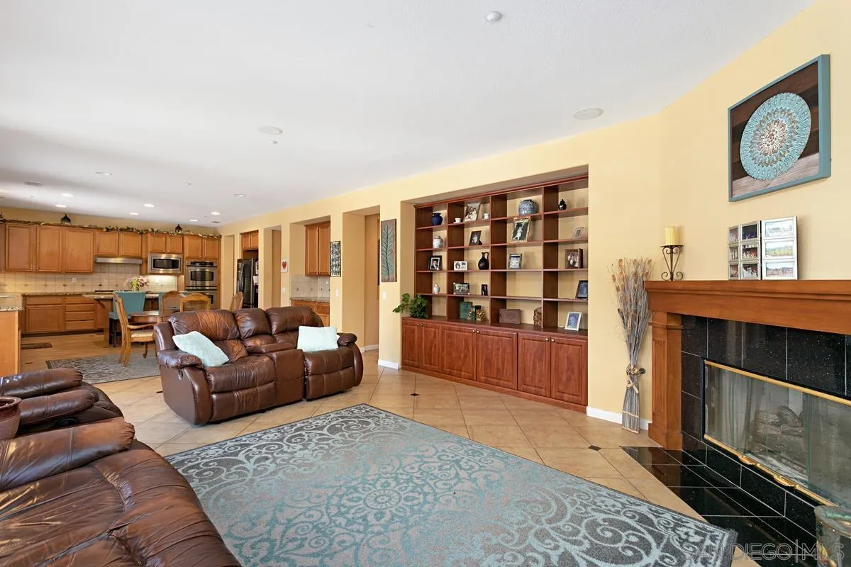 604 Hidden Trails Road Escondido, CA 92027 - Photo 10 of 49 a living room with furniture a window and a fireplace