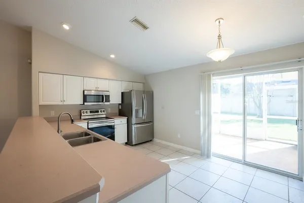 a kitchen with stainless steel appliances a refrigerator and a stove top oven