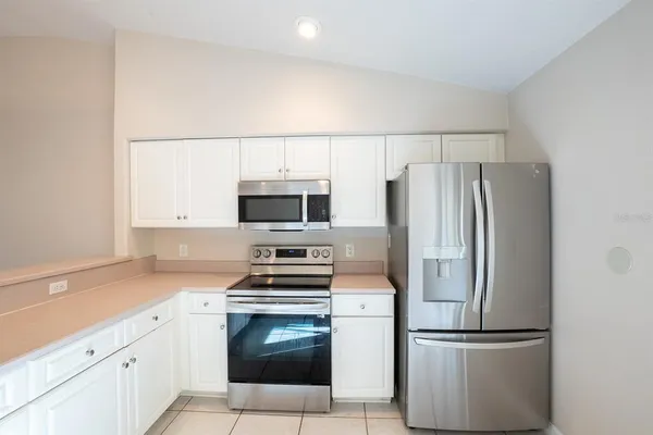 a kitchen with stainless steel appliances a refrigerator stove and microwave
