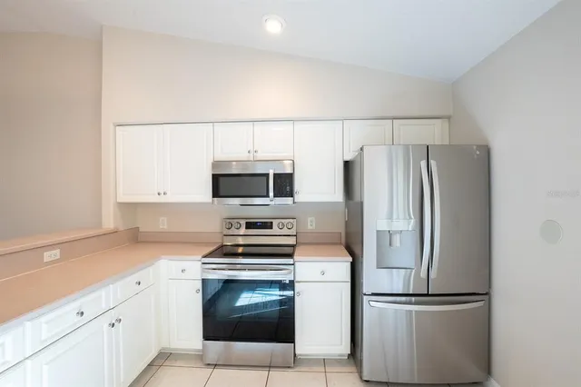 a kitchen with stainless steel appliances a refrigerator stove and microwave