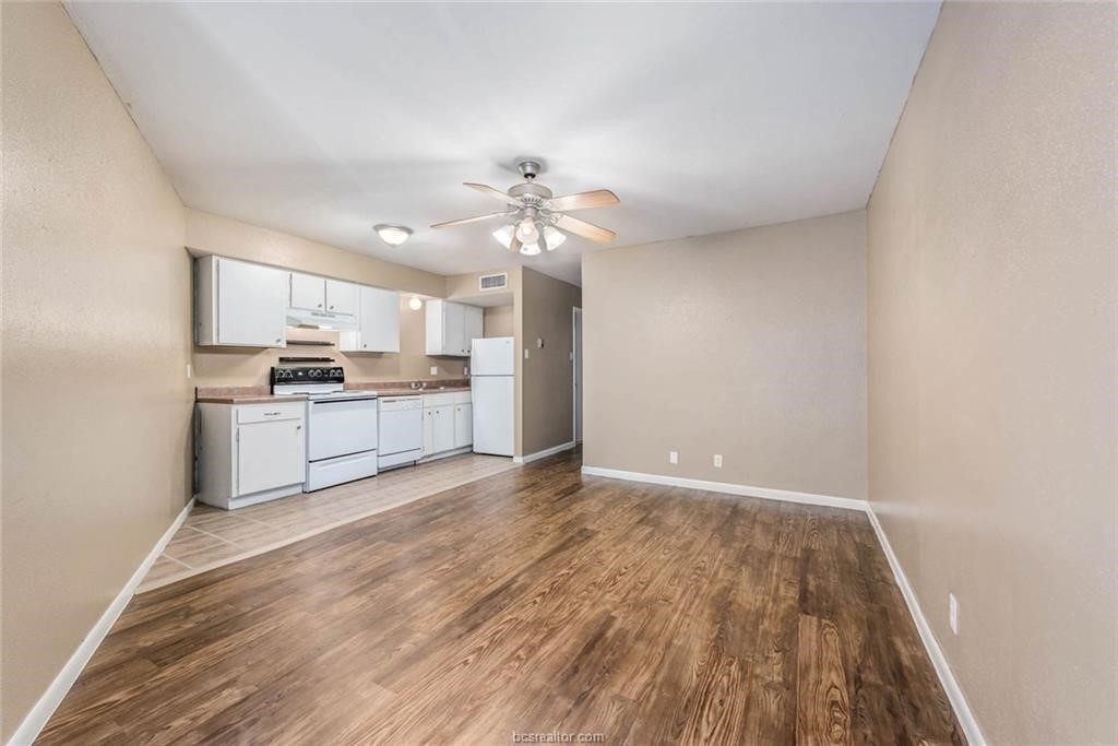 3900 Old College Road, Unit 12 Bryan, TX 77801 - Photo 3 of 12 a view of a kitchen with wooden floor and a kitchen