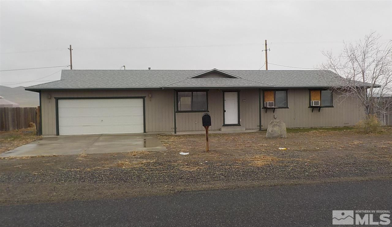 200 Reservoir Road Lovelock, NV 89419 - Photo 1 of 1 a front view of a house with a yard and garage