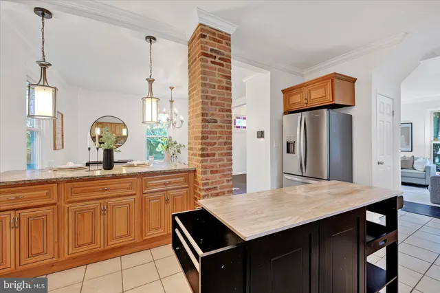 a kitchen with a sink refrigerator and cabinets