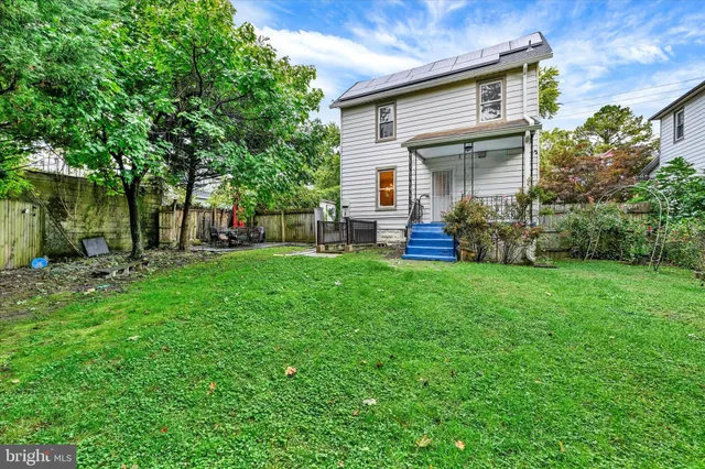 a view of a house with a yard and sitting area