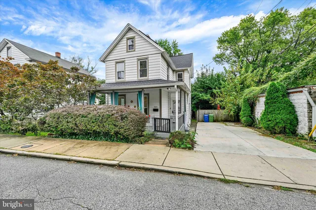 a front view of a house with a yard and a garage