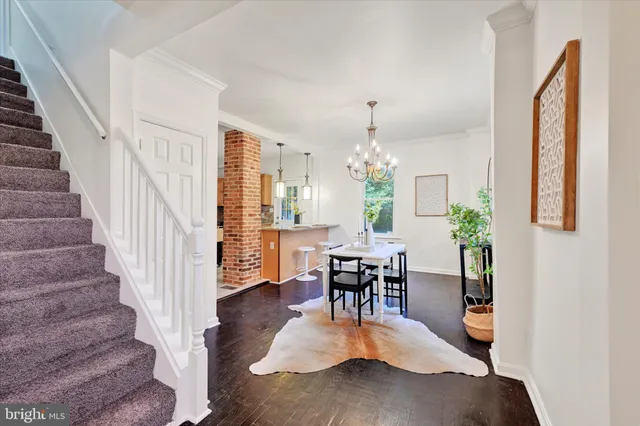 a view of hall way with furniture and wooden floor