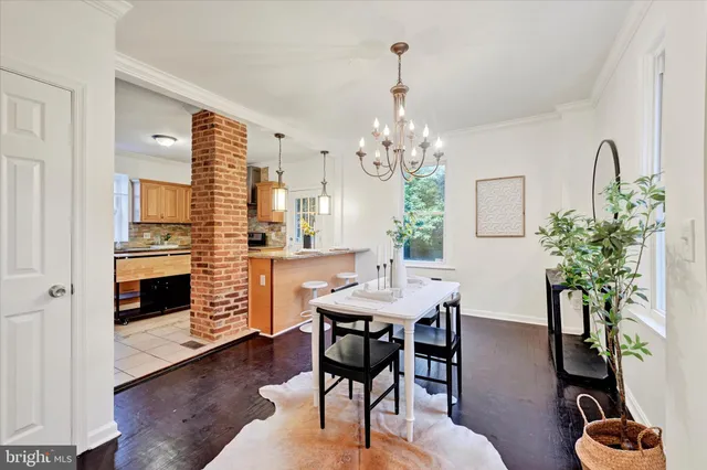 a view of a dining room with furniture and chandelier