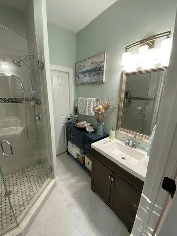 a bathroom with a double vanity sink toilet and shower