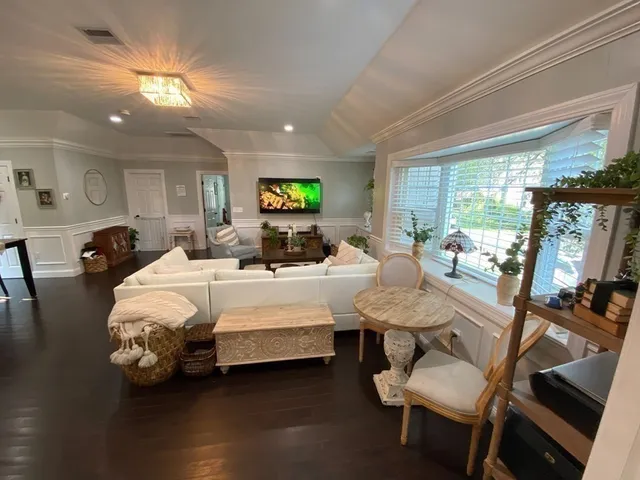 a bed room with furniture and a flat screen tv