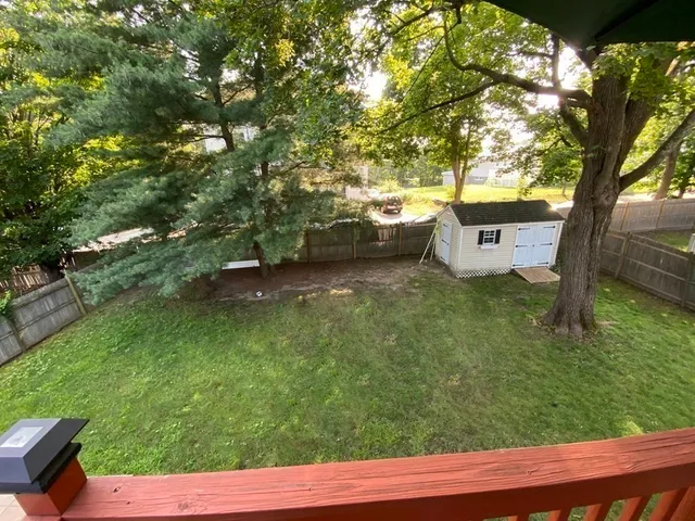 a view of a house with a yard and sitting area
