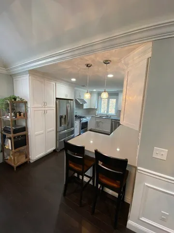 a view of a dining room with furniture and a chandelier