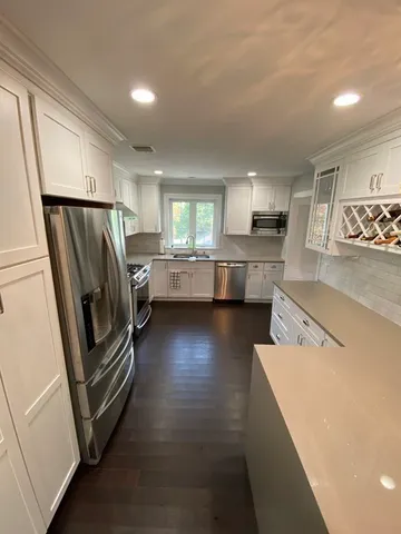 a kitchen with refrigerator and window