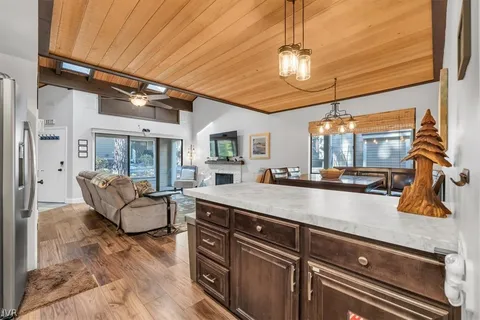 a view of living room with granite countertop furniture and a flat screen tv