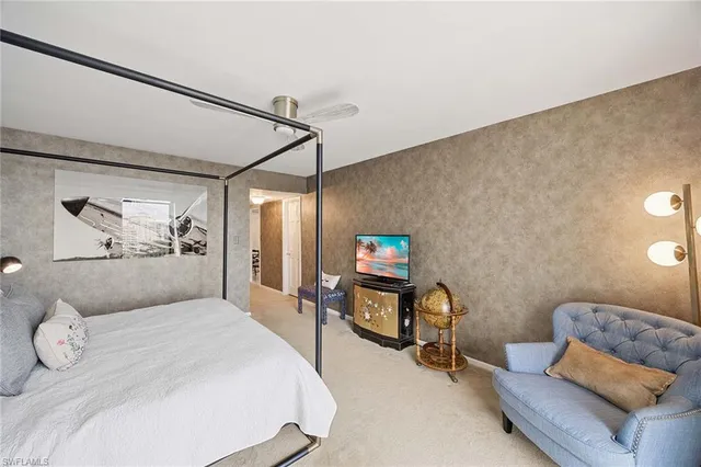 a bedroom with a bed and a couch