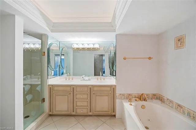 a spacious bathroom with a double vanity sink mirror and shower