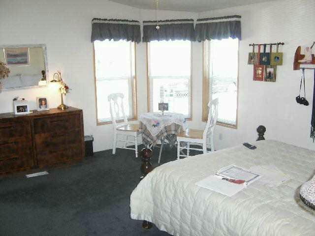 820 Tear Road Grandview, WA 98930 - Photo 5 of 6 a bed sitting in a bedroom next to a window