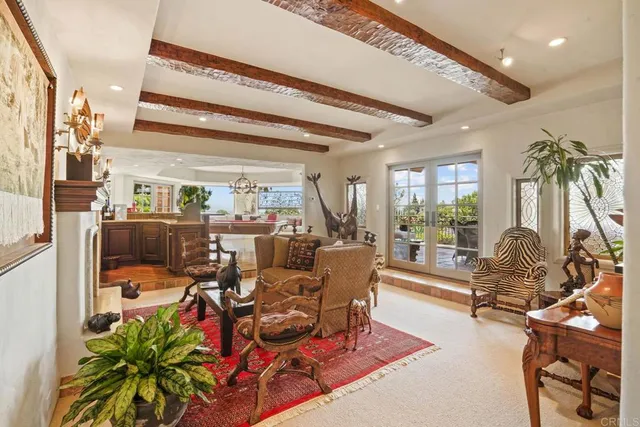 a living room with furniture fireplace and a large window