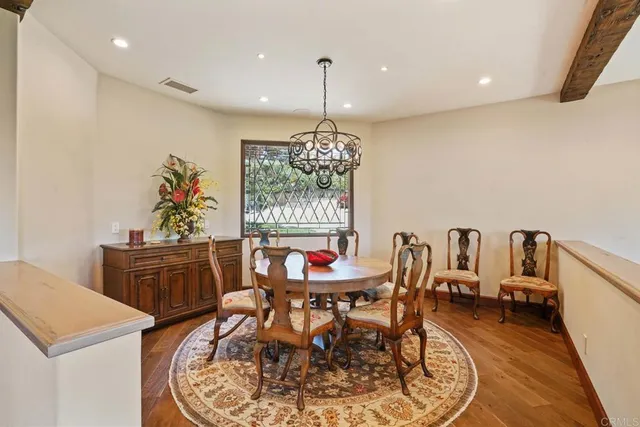 a bathroom with a granite countertop double vanity sink mirror bathtub and shower