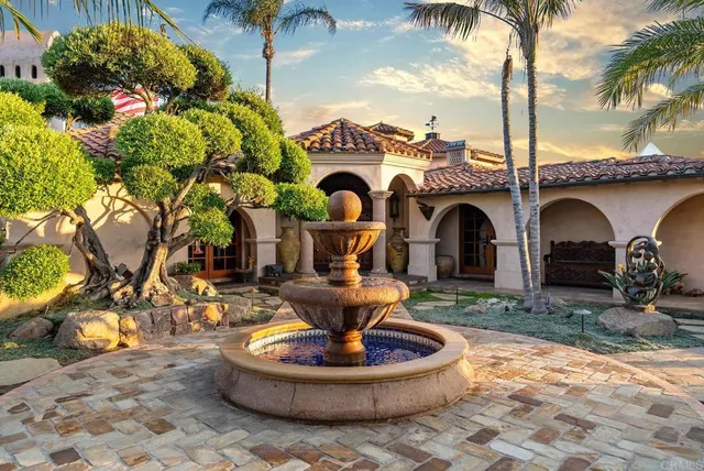 a kitchen with stainless steel appliances granite countertop a sink a stove and a wooden cabinets