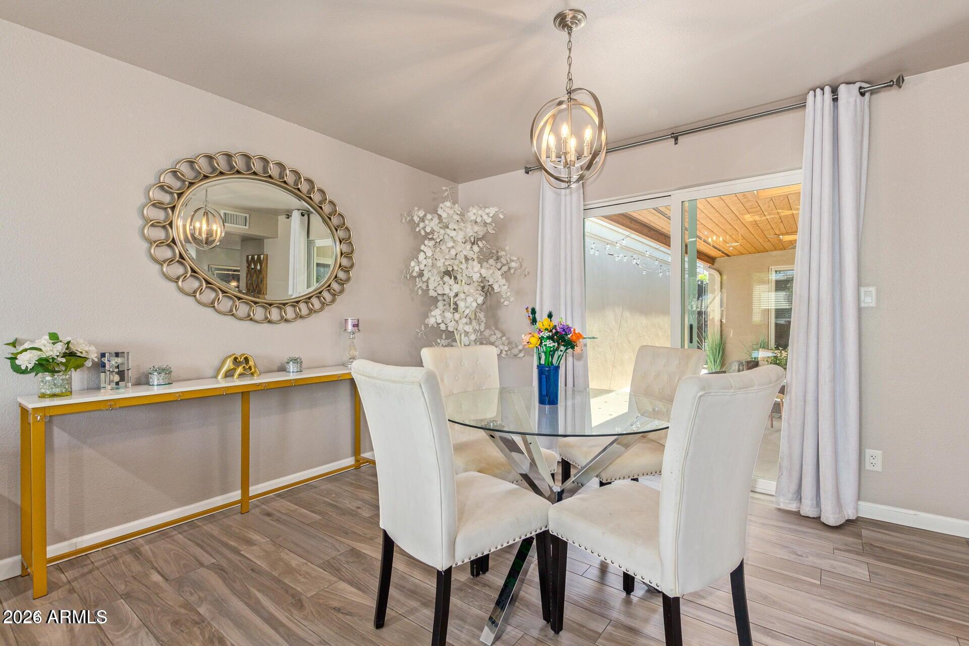 5913 East Thomas Road Scottsdale, AZ 85251 - Photo 13 of 26 a view of a dining room with furniture and wooden floor