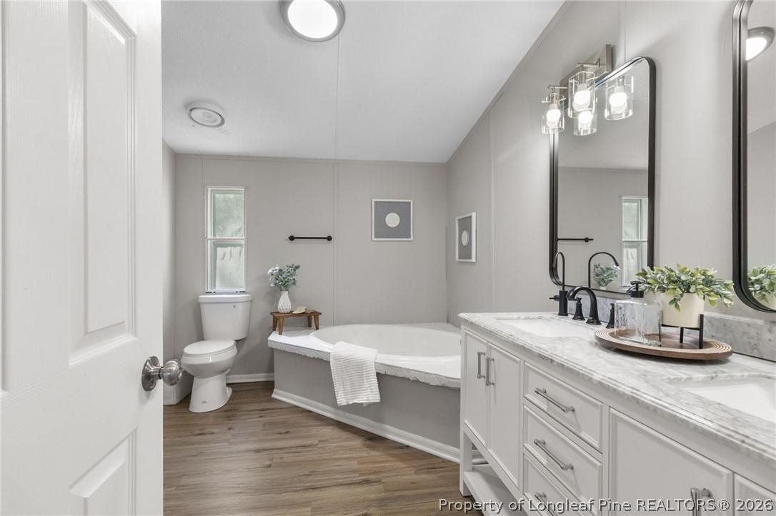 6568 Sandy Creek Road Stedman, NC 28391 - Photo 14 of 34 a bathroom with a double vanity sink and a mirror