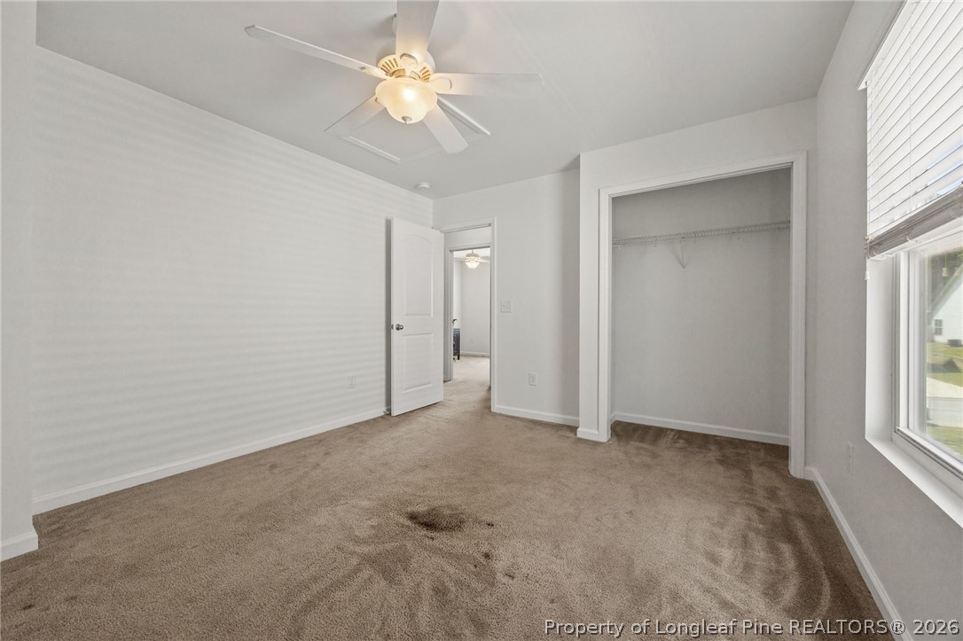 226 River Oak Street Spring Lake, NC 28390 - Photo 33 of 41 an empty room with windows and chandelier fan