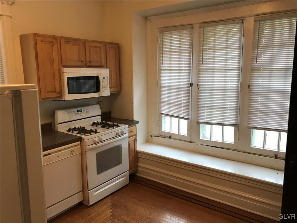 2122 Walnut Street, Unit D Allentown, PA 18104 - Photo 5 of 11 a kitchen with a stove and a microwave