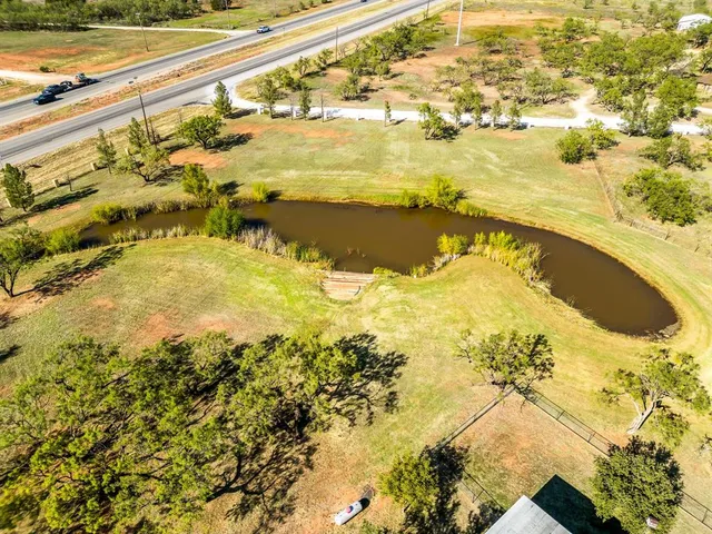 a view of a house with a yard and lake view