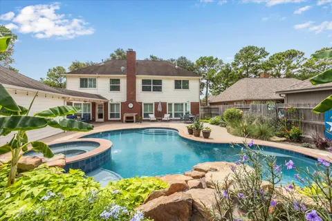 a view of a house with swimming pool and sitting area