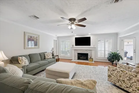 a living room with furniture a fireplace and a flat screen tv