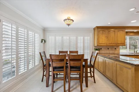 a view of a dining room with furniture and a large window