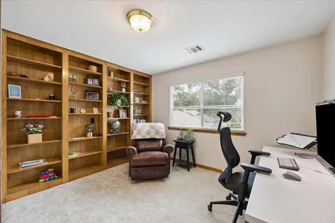 a view of workspace with wooden floor windows