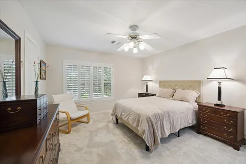 a spacious bedroom with a bed and a chandelier