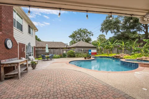 a view of a swimming pool with a patio
