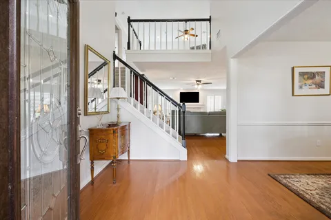 a view of entryway and hall with wooden floor