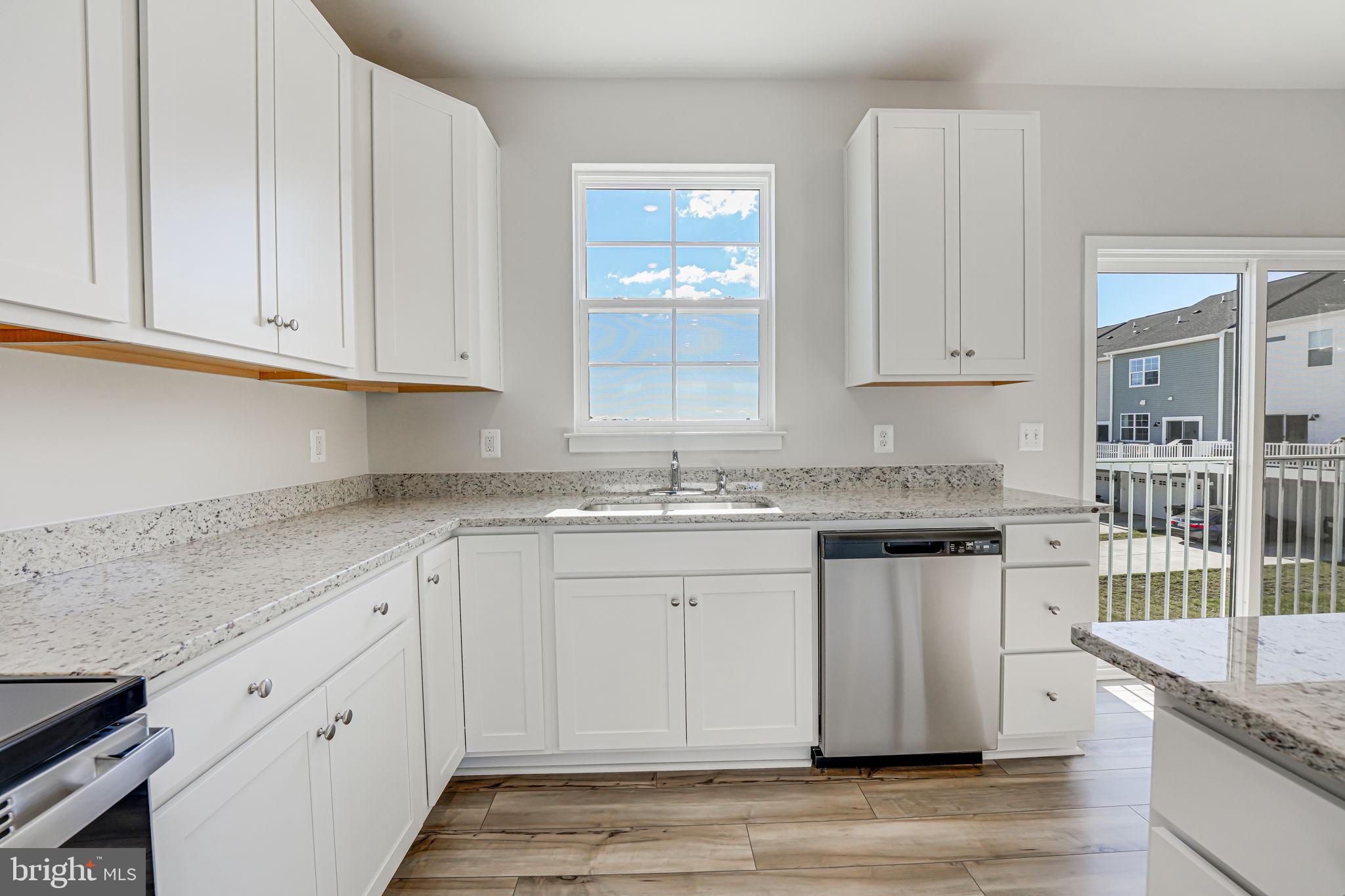 19122 Isabel Boulevard Appomattox, VA 24522 - Photo 12 of 35 a kitchen with granite countertop white cabinets and white appliances