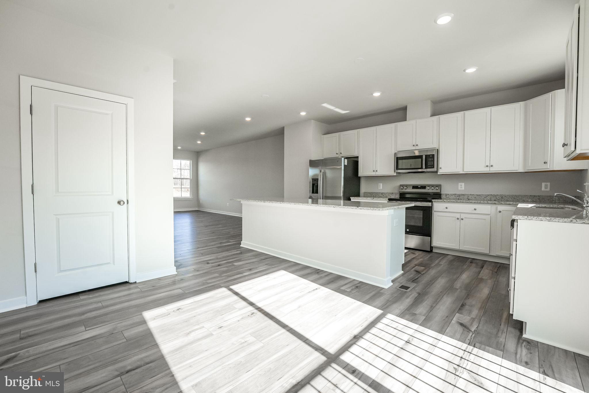 19122 Isabel Boulevard Appomattox, VA 24522 - Photo 15 of 35 a kitchen with a sink a microwave and cabinets