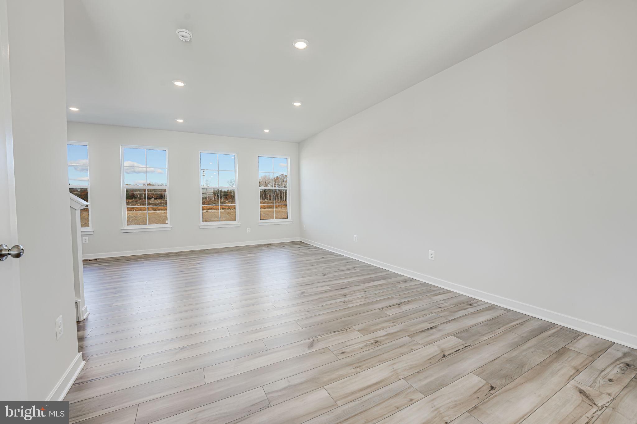 19122 Isabel Boulevard Appomattox, VA 24522 - Photo 17 of 35 an empty room with wooden floor and windows