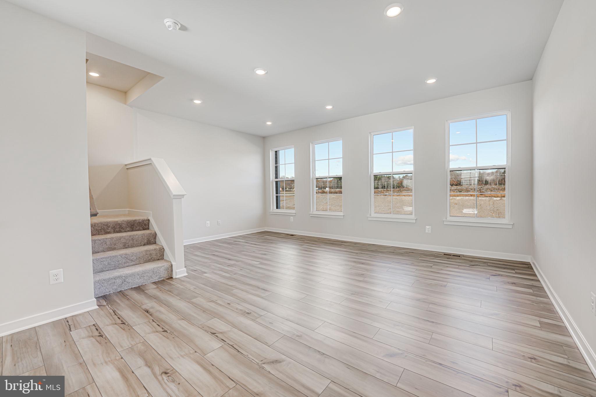 19122 Isabel Boulevard Appomattox, VA 24522 - Photo 18 of 35 a view of an empty room with wooden floor and stairs
