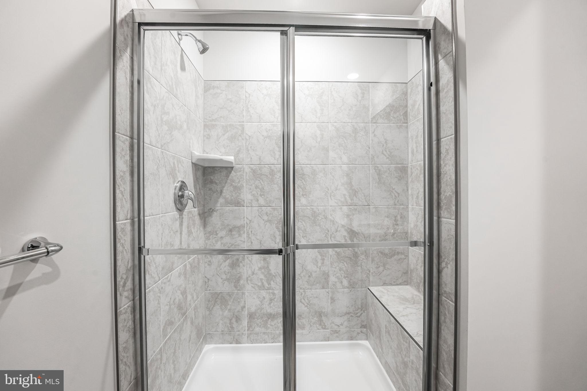 19122 Isabel Boulevard Appomattox, VA 24522 - Photo 32 of 35 a bathroom with a glass shower door