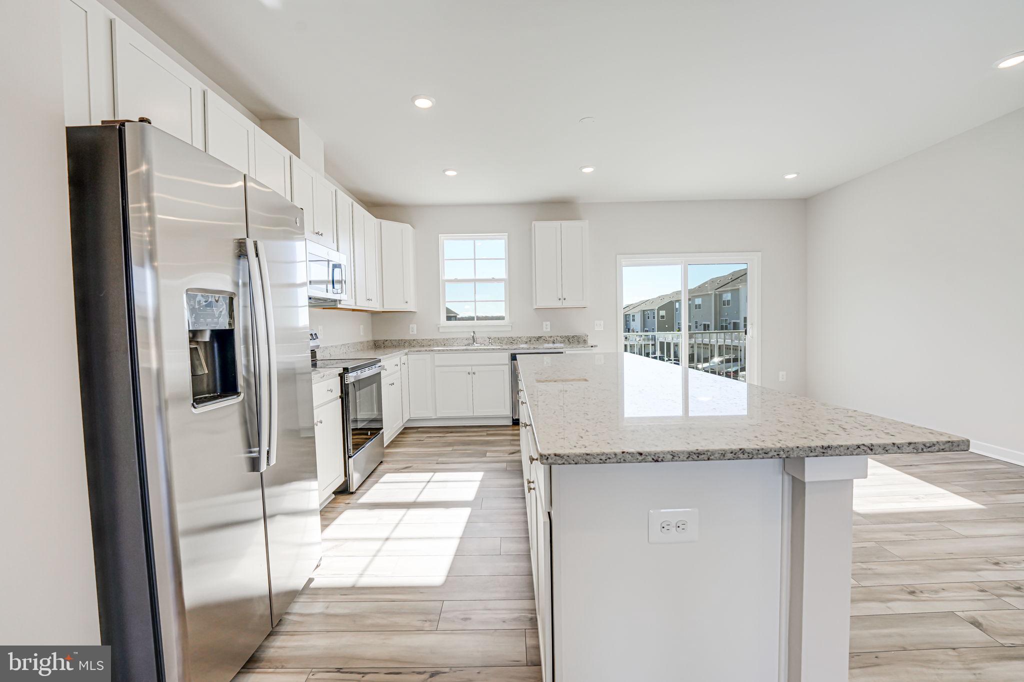 19122 Isabel Boulevard Appomattox, VA 24522 - Photo 10 of 35 a kitchen with stainless steel appliances granite countertop a refrigerator and a stove top oven