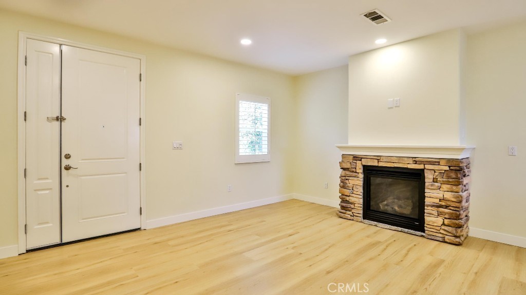 12388 Arrowhead Street Stanton, CA 90680 - Photo 12 of 69 a view of an empty room with a fireplace and a window