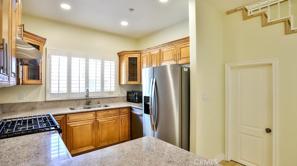 12388 Arrowhead Street Stanton, CA 90680 - Photo 14 of 69 a kitchen with stainless steel appliances granite countertop a refrigerator and a sink