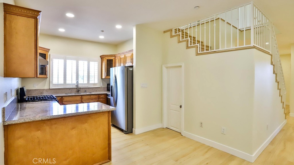 12388 Arrowhead Street Stanton, CA 90680 - Photo 15 of 69 a view of a kitchen with a refrigerator and a sink