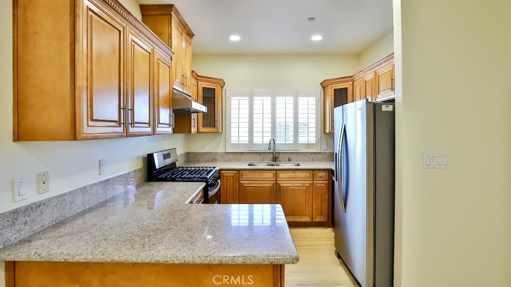 12388 Arrowhead Street Stanton, CA 90680 - Photo 17 of 69 a kitchen with stainless steel appliances granite countertop a refrigerator a oven and a sink with granite countertops