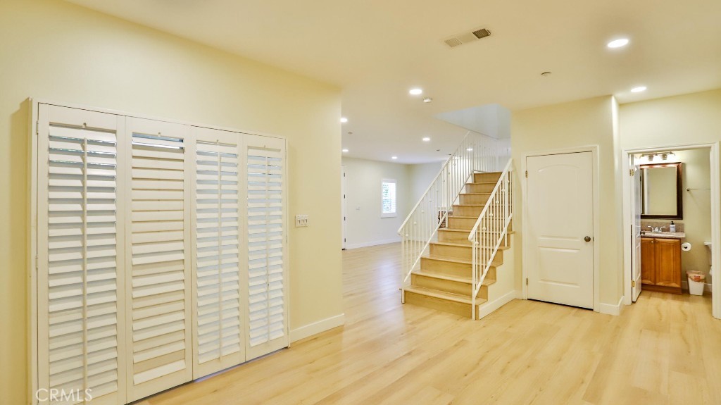 12388 Arrowhead Street Stanton, CA 90680 - Photo 22 of 69 a view of a room with stairs and wooden floor