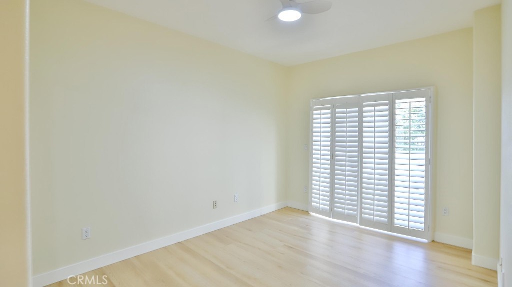 12388 Arrowhead Street Stanton, CA 90680 - Photo 30 of 69 an empty room with wooden floor and windows