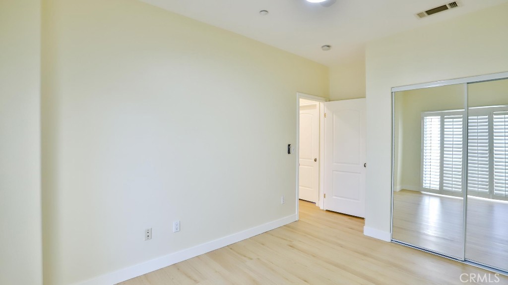 12388 Arrowhead Street Stanton, CA 90680 - Photo 31 of 69 a view of an empty room with wooden floor and a window