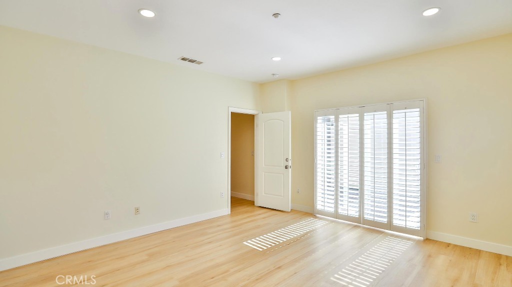 12388 Arrowhead Street Stanton, CA 90680 - Photo 35 of 69 a view of an empty room with wooden floor and a window